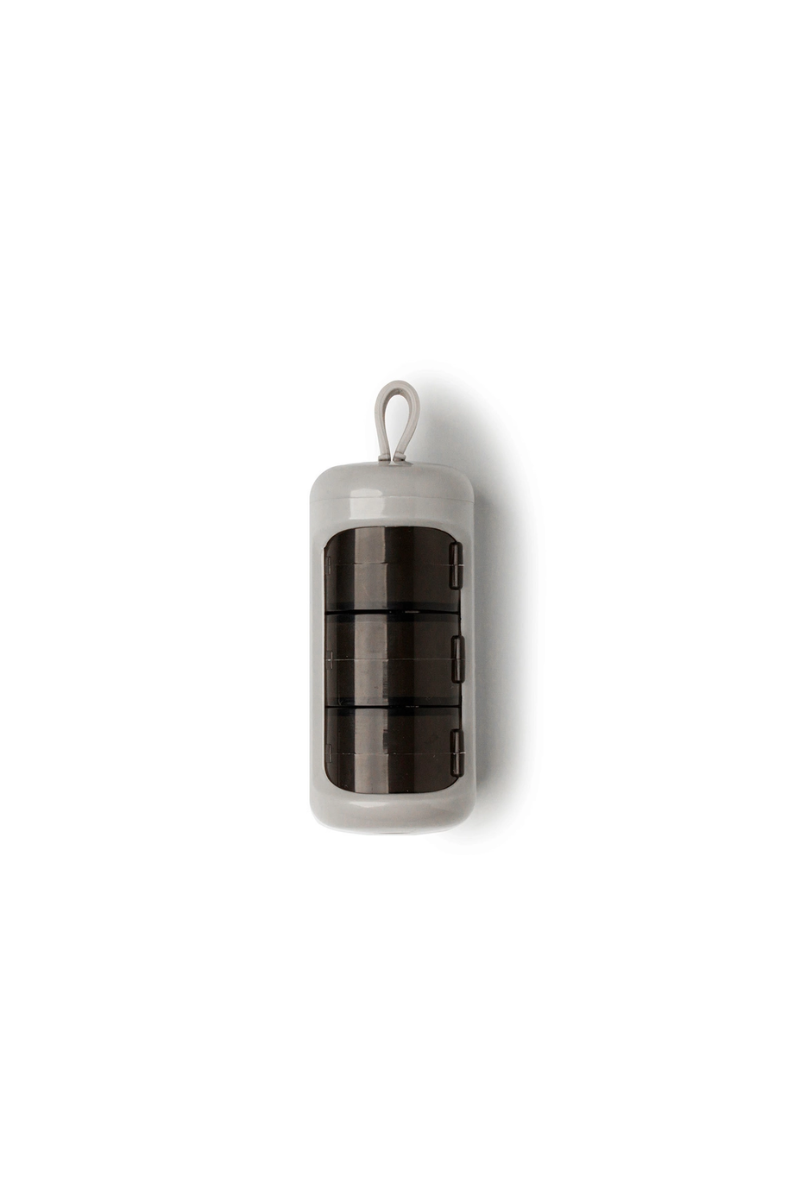 A grey cylindrical pill case.