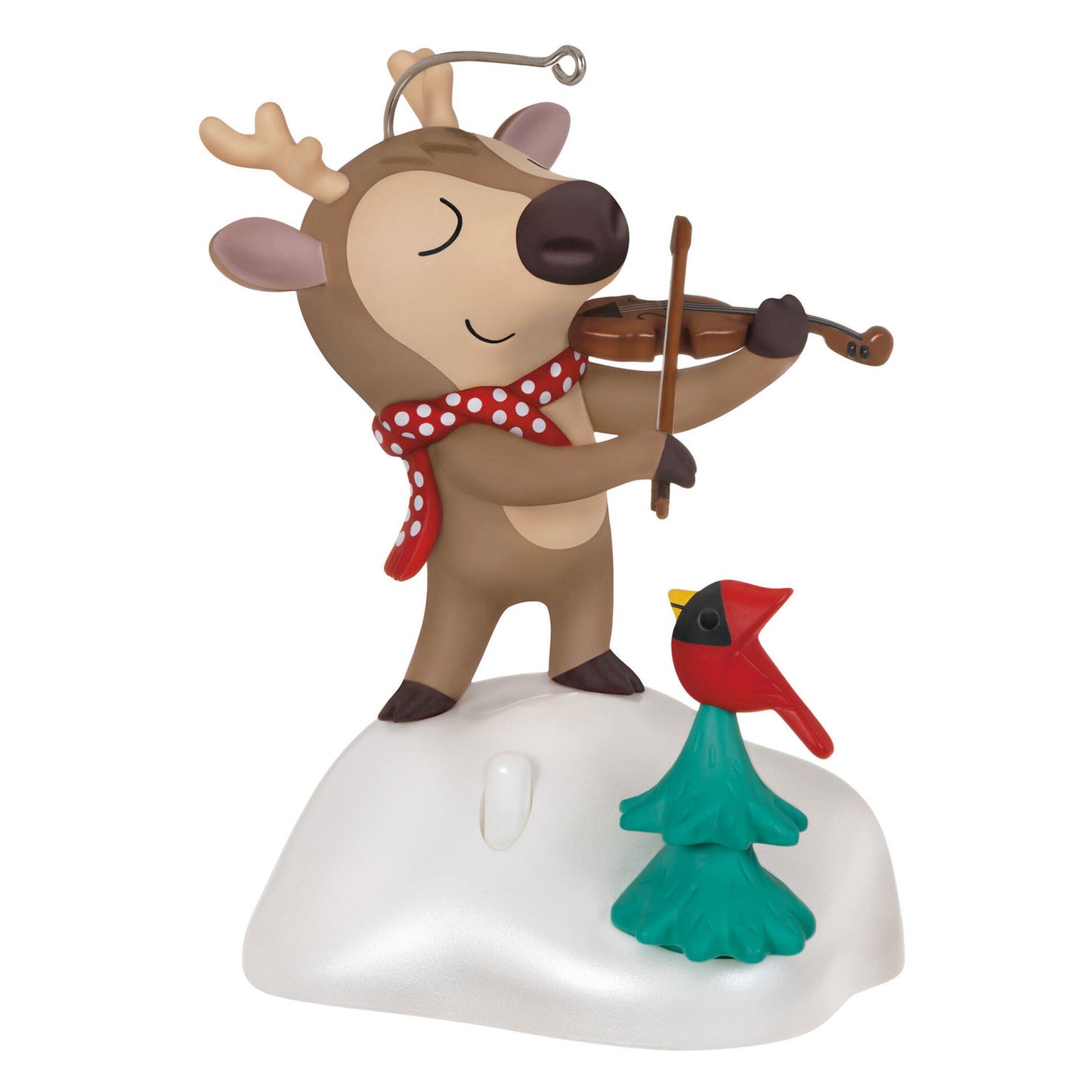 Christmas ornament depicting a reindeer with a red and white polka dotted scarf, standing on a snowy hill playing a violin. There is a small evergreen tree in front of him with a red cardinal perched on top. 