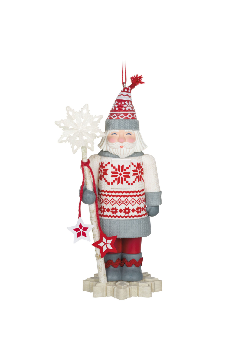 A red, white, and grey Christmas ornament of Santa holding a staff with a snow flake on the top.