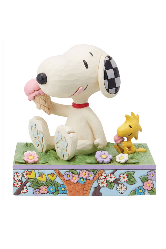 Spring themed figuring of Snoopy and Woodstock siting on the grass eating ice cream. The base of the figurine is sky blue with floral embellishments. 