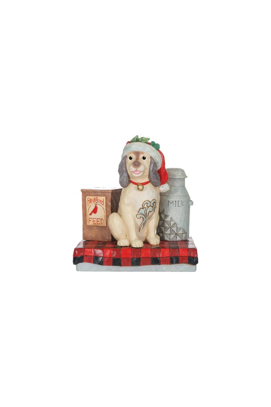 Ornament of a dog with a old timey jug of milk and a bag of bird feed on either side. 