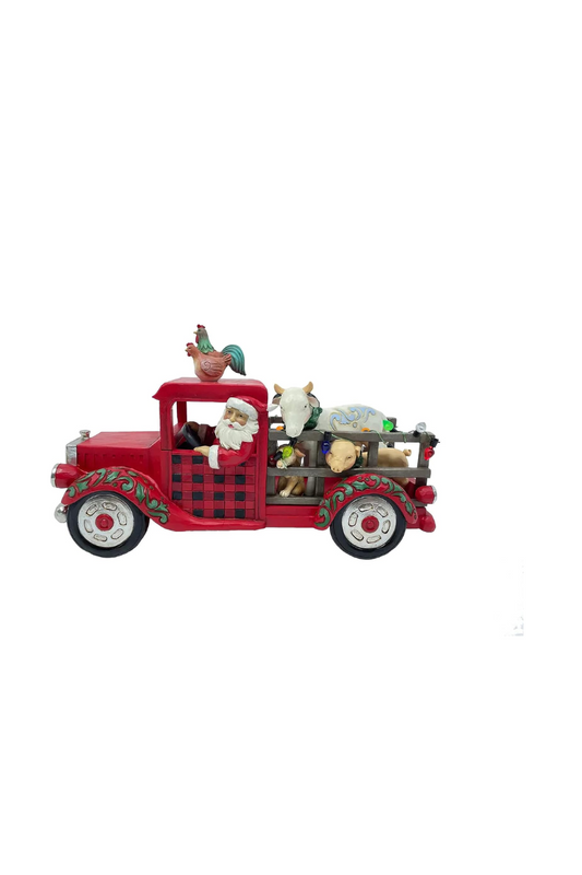 Ornament depicting Santa driving a red farm truck with chickens on top and livestock in the back.